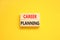 Career planning symbol. Concept words Career planning on beautiful wooden block. Beautiful yellow table yellow background.