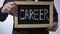 Career written on blackboard, business person holding sign, motivation, future