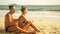 Carefree barefoot loving couple having sun block. Woman to put s