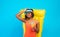 Carefree black lady in bikini lying on inflatable lilo with glass of tropical cocktail over blue background, panorama