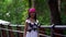 Carefree black woman is walking alone in park in summer day, wearing folk gown