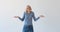 Carefree Caucasian Blonde Woman Shrugging on White Background