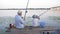 Carefree childhood, happy family little boy and man fishing for fishing rod sitting on pier near river during lazy