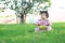 Carefree Chinese baby girl play a ball and balloon on the lawn