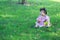 Carefree Chinese baby girl play a ball on the lawn