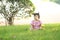 Carefree Chinese baby girl play a ball on the lawn