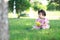 Carefree Chinese baby girl play a ball on the lawn