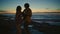 Carefree couple dancing together evening beach. Man playing guitar kissing girl