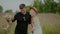 Carefree Couple in Love Walking on a Meadow in Countryside on Holidays.