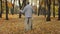 Carefree elderly caucasian grandparents family dancing romantic dance together in autumn park happy aged older couple