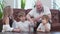 Carefree family of two sons playing in board game, wooden tower in living room