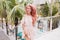 Carefree happy girl with pink hair dancing outdoor. Blissful european woman in beautiful summer dre