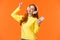 Carefree happy redhead teenage girl receive new headphones for christmas gift, dancing lift hand up while listen