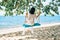 Carefree happy woman on swing on beautiful paradises beach