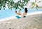 Carefree happy woman on swing on beautiful paradises beach