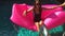 Carefree Happy Young Girl Sunbathing on Pink Inflatable Mattress in the Swimming Pool. Lifestyle HD Slowmotion.