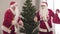 Carefree joyful Santas dancing indoors with decorated Christmas tree at the background. Portrait of two cheerful Santa