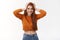 Carefree leisure, beauty and emotions concept. Cheerful tender feminine young redhead woman in cropped sweater, holding