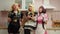 Carefree lovely multiracial women in costumes having fun during cosplay party