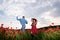 Carefree lovers. Couple in love on poppy summer field. Well being holiday vacation, country nature.