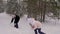 Carefree mom and daughter playing to snow fight in winter forest slow motion