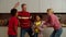 Carefree multicultural grandchildren with grandparents having fun dancing indoor