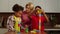 Carefree multicultural kids and grandmother playing with toy building blocks