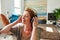 Carefree older woman listening to music at home