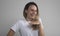 Carefree portrait of a young caucasian woman laughing and having fun. real person on grey studio background