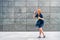 Carefree redhead woman celebrating blowing soap bubbles in town