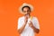 Carefree relaxed and joyful, outgoing african-american male drinking cocktail with straw, holding glass with drink