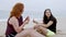 A carefree relaxing day at the beach - beautiful girls on summer holiday