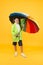 Carefree schoolgirl colorful umbrella wear waterproof rain coat. Autumn rain. Going to school rainy days more fun with