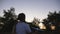 Carefree small girl plays with airplane going on rural trail at dusk time. Cute kid walking with toy plane in hand