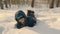 Carefree teenager boy falling in snowdrift while winter walk in snowy forest