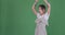 Carefree woman dancing over green background