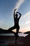 Carefree woman dancing in the sunset on the beach.Vacation vitality healthy living concept.Free woman enjoying freedom feeling hap