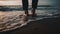 A carefree woman walks on wet sand at dawn, enjoying nature generated by AI