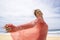 Carefree Woman Wearing Scarf Standing On Beach