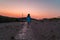 Carefree women at the beach at sunset during golden hour