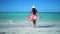 Carefree young woman relaxing on exotic beach. Caribbean tropical vacation