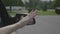 Carefree young woman waving her arm outside of moving car window