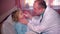 Careful doctor using nasal spray for stuffy nose little girl boy patient