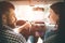 Careful driving. Beautiful young couple sitting on the front passenger seats and smiling while handsome man driving a