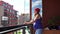 Careful pregnant woman wipe window dust in flat house balcony