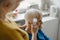 Caregiver checking temperature of elderly woman