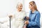 Caregiver doing blood pressure monitoring for senior woman