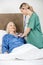 Caregiver Examining Senior Woman With Stethoscope