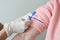 Caregiver hands sterile gloves putting tourniquet arm