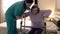 Caregiver helping senior woman getting up and walk with a walker